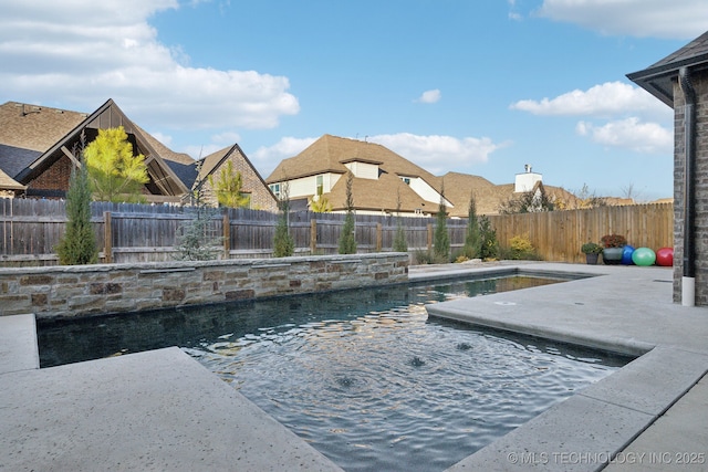 view of pool featuring pool water feature and a patio area