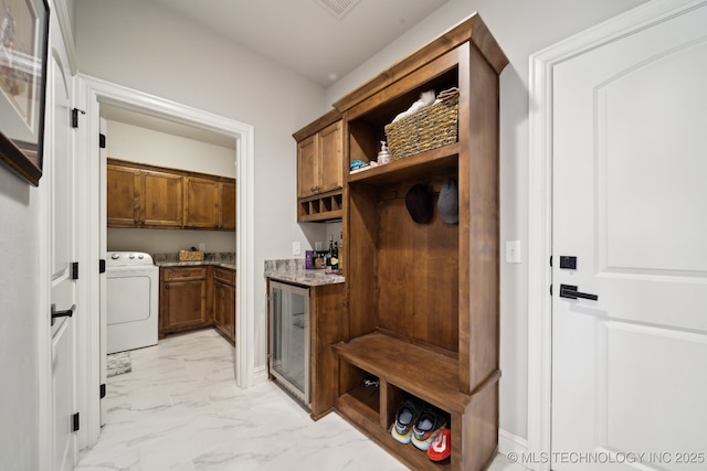 mudroom featuring washer / clothes dryer and bar area