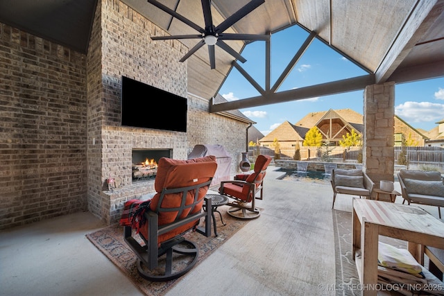 view of patio featuring ceiling fan and an outdoor brick fireplace