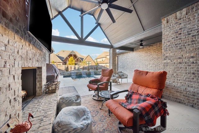 view of patio with ceiling fan and an outdoor stone fireplace