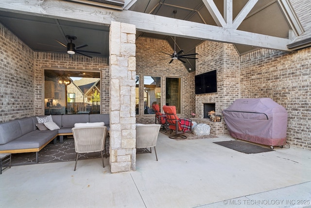 view of patio featuring ceiling fan, a grill, and an outdoor living space with a fireplace