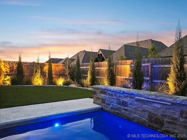 pool at dusk with a yard