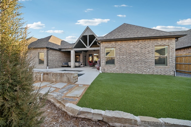 rear view of house with a patio area and a yard