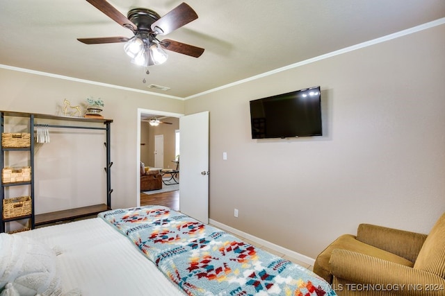 bedroom with hardwood / wood-style flooring, ceiling fan, and ornamental molding