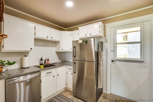 kitchen featuring white cabinets, stainless steel appliances, crown molding, and sink