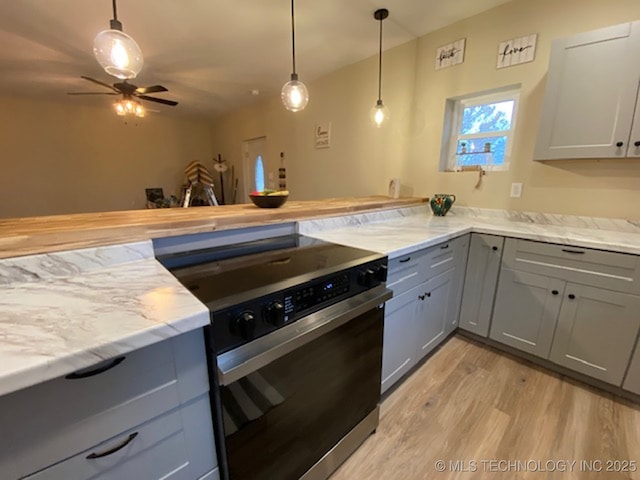 kitchen with gray cabinetry, hanging light fixtures, electric range, ceiling fan, and light wood-type flooring