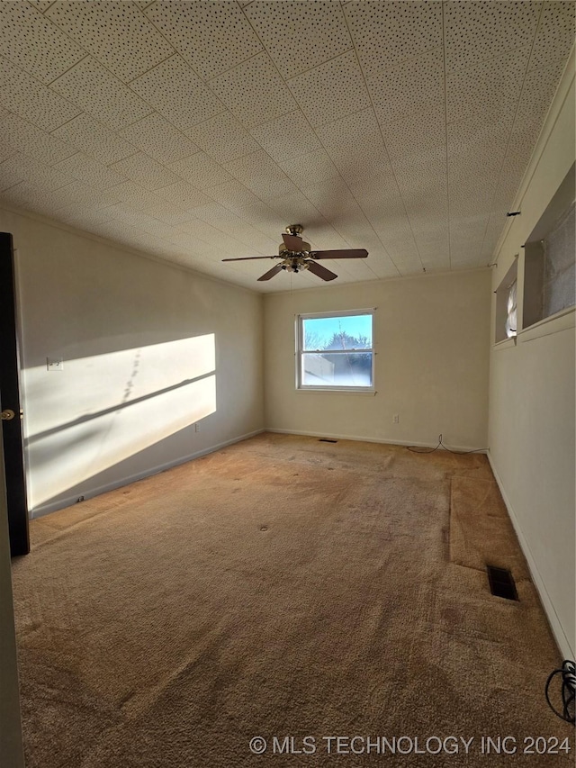 empty room with carpet flooring, a textured ceiling, and ceiling fan