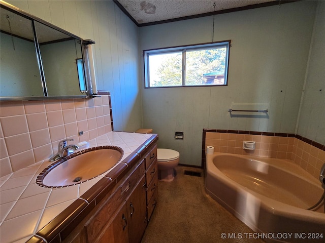 bathroom featuring vanity, toilet, a textured ceiling, and a tub