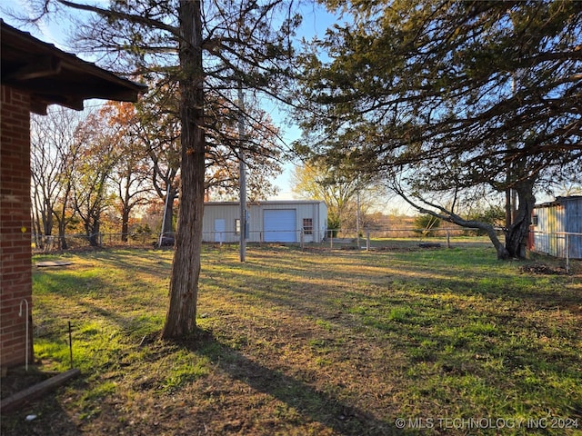 view of yard featuring an outbuilding and a garage