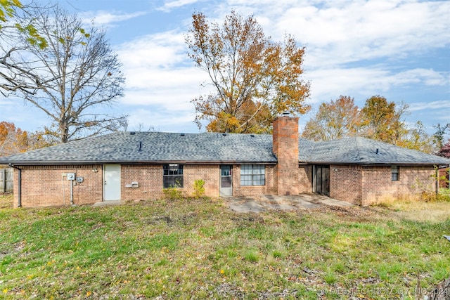 rear view of property with a lawn