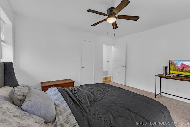 carpeted bedroom with ceiling fan