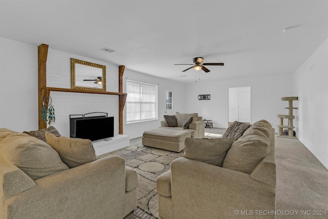 carpeted living room featuring ceiling fan