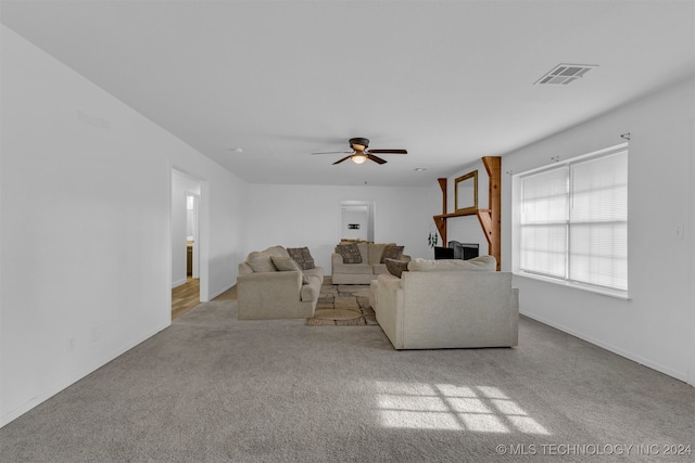 unfurnished living room with light carpet and ceiling fan