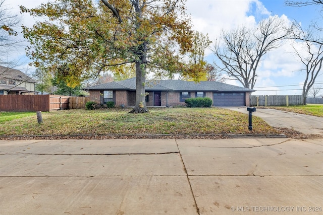 ranch-style house with a front yard and a garage