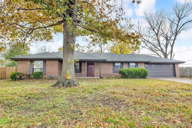 single story home featuring a front yard and a garage