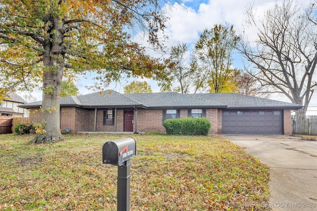 ranch-style home with a garage and a front yard