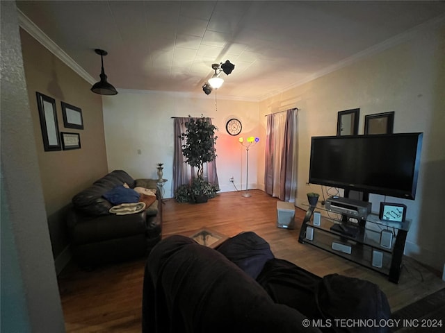 living room with crown molding and hardwood / wood-style flooring