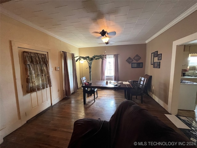 dining room with ceiling fan, ornamental molding, and dark wood-type flooring