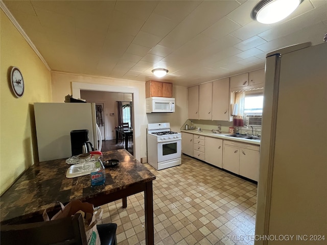 kitchen with sink, white appliances, and ornamental molding