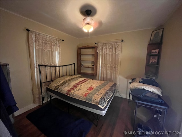 bedroom featuring dark hardwood / wood-style floors and ceiling fan