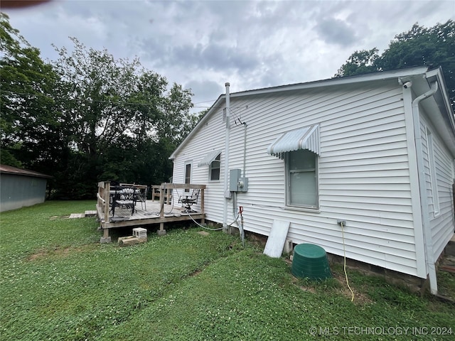 back of house featuring a yard and a deck