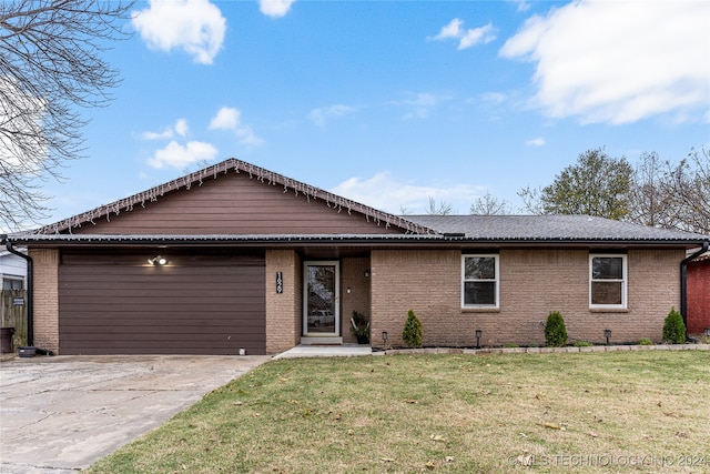 ranch-style home featuring a garage and a front lawn