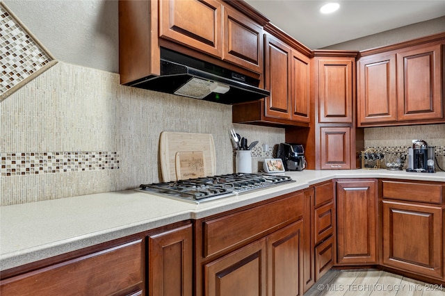 kitchen featuring stainless steel gas stovetop and tasteful backsplash