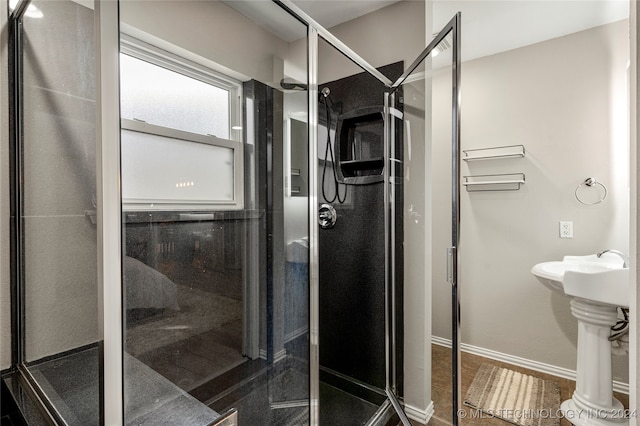 bathroom featuring a shower with shower door