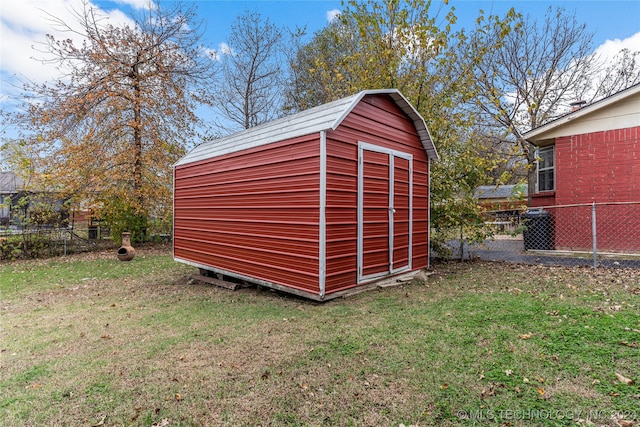 view of outbuilding with a yard