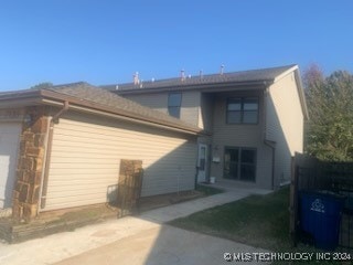 rear view of property with a garage