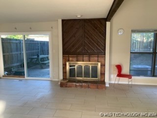 unfurnished living room featuring a large fireplace