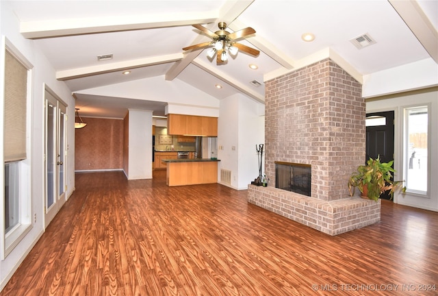 unfurnished living room with vaulted ceiling with beams, ceiling fan, dark hardwood / wood-style flooring, and a brick fireplace