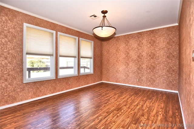 unfurnished room with dark wood-type flooring and ornamental molding