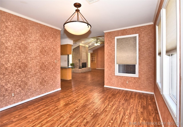 spare room with ceiling fan, dark hardwood / wood-style flooring, crown molding, and vaulted ceiling