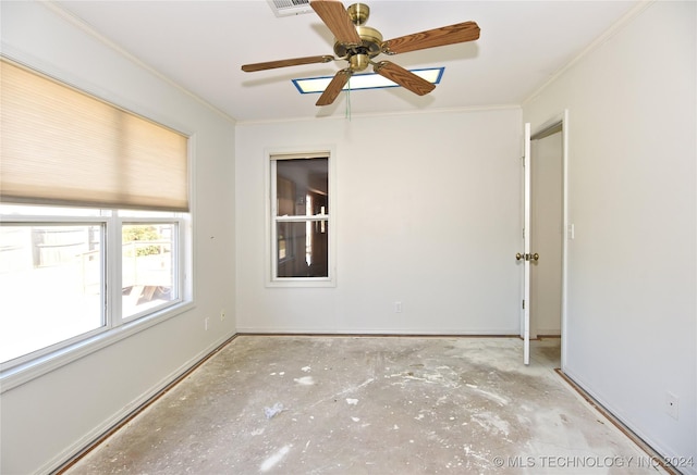 unfurnished room featuring ceiling fan and crown molding