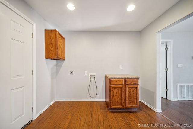 laundry area featuring hookup for an electric dryer, dark hardwood / wood-style floors, cabinets, and hookup for a washing machine