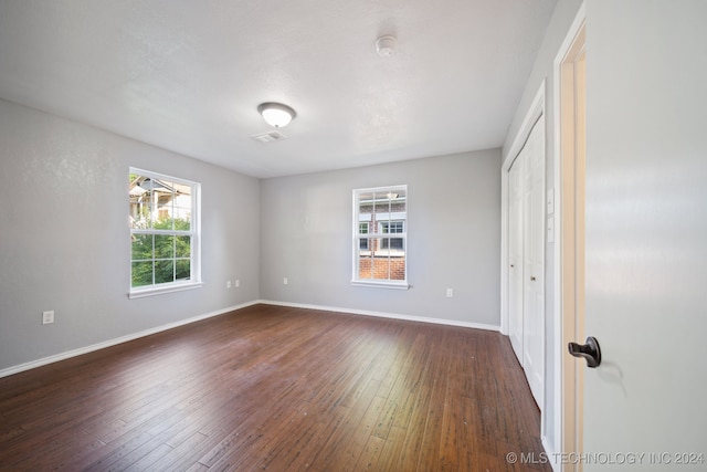 unfurnished bedroom with dark hardwood / wood-style floors