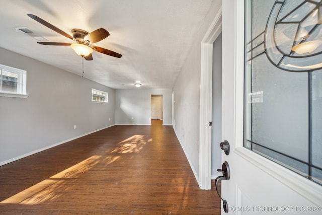 unfurnished room featuring ceiling fan and dark hardwood / wood-style flooring