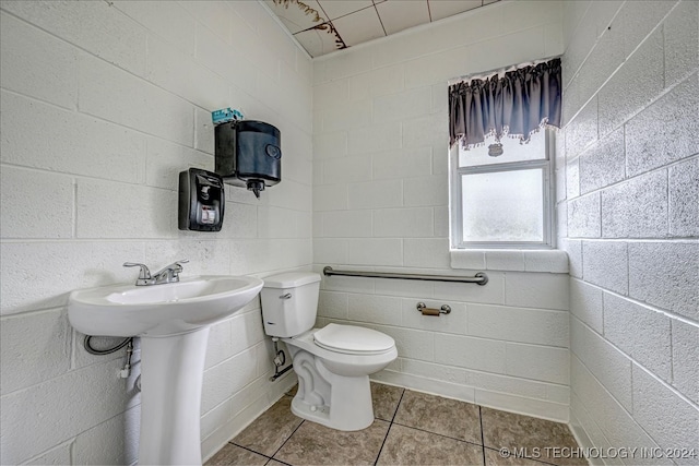 bathroom with tile patterned flooring, toilet, and sink