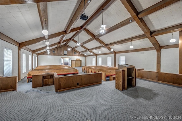 game room with wood walls, dark carpet, and a wealth of natural light