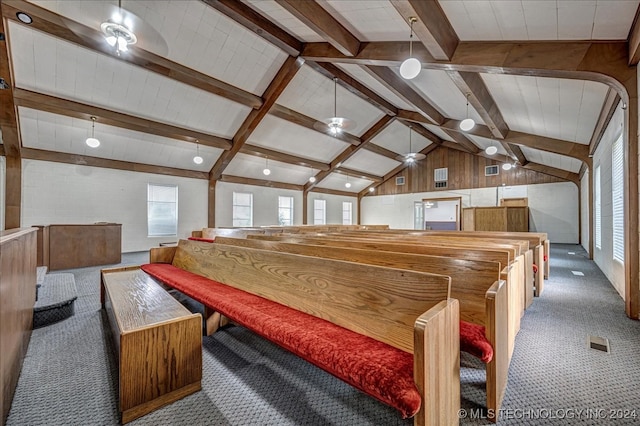 playroom featuring vaulted ceiling with beams, wood walls, carpet, and ceiling fan