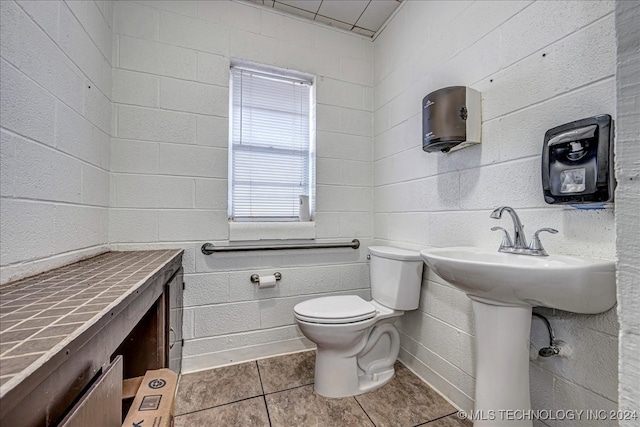 bathroom with tile patterned floors and toilet