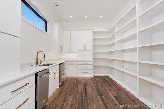 interior space with open shelves, light stone countertops, dark wood finished floors, white cabinets, and a sink