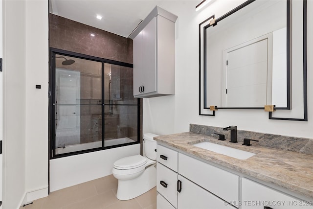 full bath with enclosed tub / shower combo, tile patterned floors, toilet, and vanity