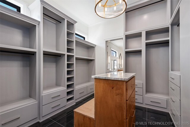 spacious closet featuring dark tile patterned floors