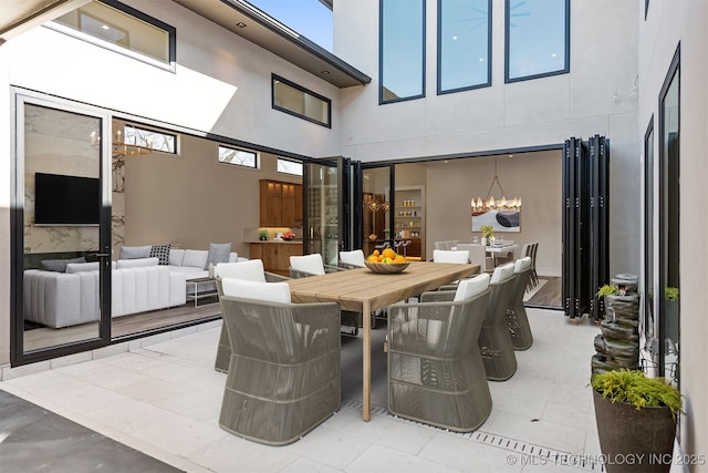 view of patio / terrace with outdoor dining space and an outdoor hangout area