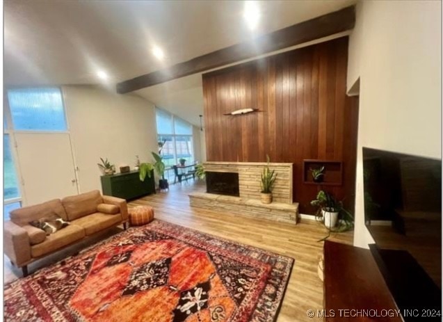 living room with wooden walls and hardwood / wood-style floors