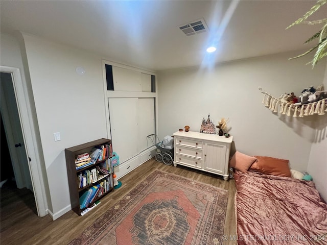 bedroom featuring a closet and dark wood-type flooring