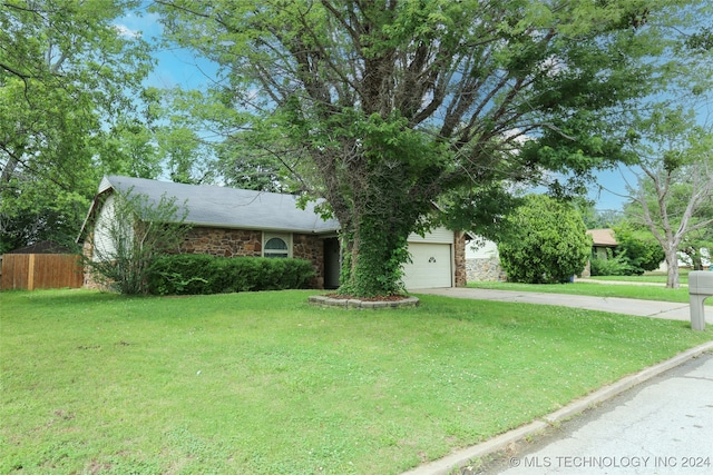 ranch-style house featuring a front yard and a garage