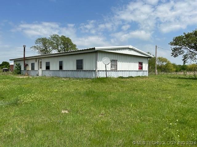 340 Clay Hl, Lone Grove, OK 73443 - view of side of home with a lawn